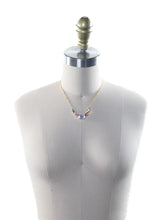 Load image into Gallery viewer, Mannequin wearing a necklace with colorful gemstones on a white background.
