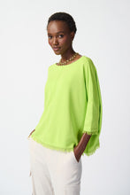 Load image into Gallery viewer, Elevate your style effortlessly with our soft and elegant Key Lime Poncho. The boat neck and cascading fringes add a touch of luxury to this practical three-quarter sleeve garment. Perfectly paired with tailored trousers for a polished look or for a chic and casual vibe with skinny jeans, ankle boots or sandals. Color- Key lime. Soft viscose. Boat neck. Three-quarters sleeves. Cuff hem, fringes at the bottom. Unlined.
