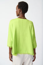Load image into Gallery viewer, Elevate your style effortlessly with our soft and elegant Key Lime Poncho. The boat neck and cascading fringes add a touch of luxury to this practical three-quarter sleeve garment. Perfectly paired with tailored trousers for a polished look or for a chic and casual vibe with skinny jeans, ankle boots or sandals. Color- Key lime. Soft viscose. Boat neck. Three-quarters sleeves. Cuff hem, fringes at the bottom. Unlined.
