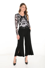 Load image into Gallery viewer, Woman wearing a patterned , black pants and black heels against  a white background.
