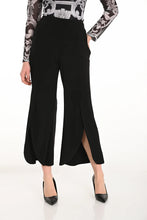Load image into Gallery viewer, Close up of a woman wearing black wide leg pants with scalloped hem, black heels and printed top against a white background.
