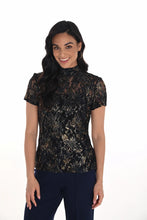 Load image into Gallery viewer, Model wearing a navy and gold floral lace short sleeve top and navy pants against a white background.
