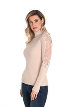 Load image into Gallery viewer, Enhance your wardrobe with the sophisticated Brixley knit sweater. This beige turtleneck features exquisite lace detailing on the arms, elevating its style. Combining comfort and charm, the Brixley is ideal for layering or standalone wear. Its neutral hue adds versatility to any outfit.
