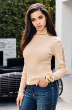 Load image into Gallery viewer, Enhance your wardrobe with the sophisticated Brixley knit sweater. This beige turtleneck features exquisite lace detailing on the arms, elevating its style. Combining comfort and charm, the Brixley is ideal for layering or standalone wear. Its neutral hue adds versatility to any outfit.
