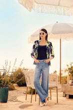 Load image into Gallery viewer, The Kiera Knit Sleeveless Top in deep navy is a sophisticated addition to any collection, featuring delicate crystal embellishments at the neckline and straps that add a touch of refined glamour. Designed by Frank Lyman, this piece boasts a flattering sleeveless cut and soft knit fabric for effortless comfort and chic versatility. Perfect for both formal occasions and elevated casual styling, it pairs beautifully with tailored pants or statement skirts.
