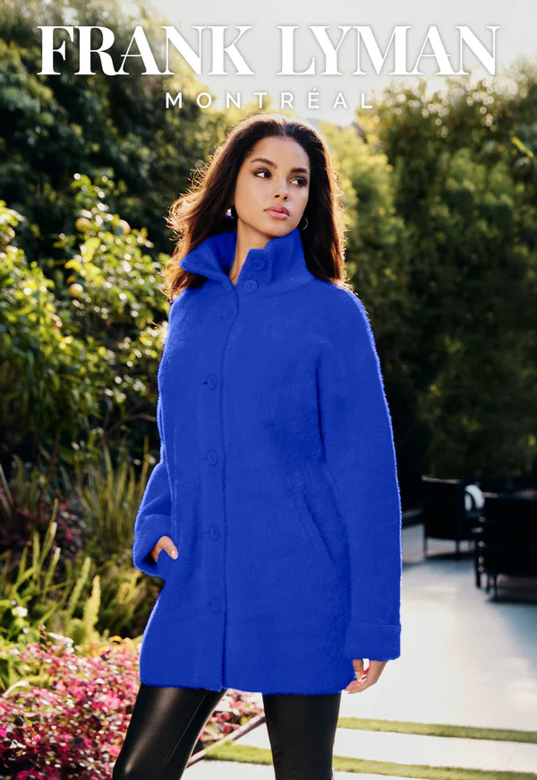 Woman wearing a blue coat with 'Frank Lyman Montreal' branding against an outdoor setting.