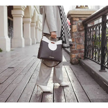 Load image into Gallery viewer, This Kylie Top Handle Black and White Satchel Handbag by Mia K.- MKF Collection is perfect for the modern stylish woman. Crafted of high-quality vegan leather with luxurious gold-tone hardware and top magnetic snap closure, this handbag is both fashionable and functional. It also features optional shoulder strap, metal feet, faux snakeskin interior lining, and two slip in pockets and a wall zipper pocket for organized storage.
