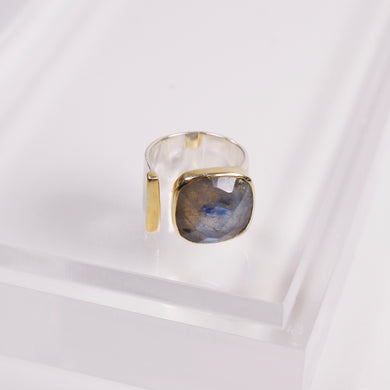 This Selma Gold and Silver Labradorite Ring is sure to turn heads. The stunning statement ring features a mixed-metal design with sterling silver and 18k gold overlay. Available in sizes 6, 7, and 8.  Color- Gold, silver and gray. Labradorite stone. 18K gold overlay over sterling silver.