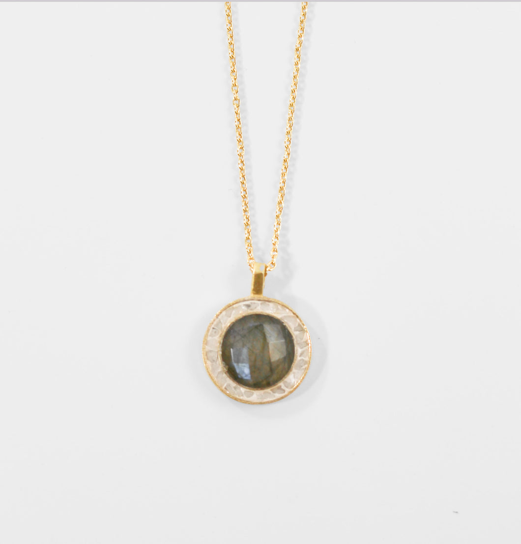 A faceted labradorite stone, encircled by white sparking deco diamonds, graces this bold and chic pendant. The brass necklace is plated with 18 carat gold micron for a luxurious finish, measuring 1 inch in diameter and 16 inches in length with a 2-inch extender. Pairs beautifully with our Betsy's Black Deco Diamond Favorite Ring - Joya.