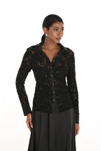 Load image into Gallery viewer, Woman wearing a black lace blouse and black skirt against a white background.
