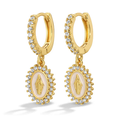 Gold huggie earrings with central white oval design and a Virgin Mary icon surrounded by small crystals against a white background.
