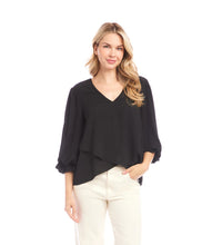 Load image into Gallery viewer, Woman wearing a black blouse and off-white pants against a white background.
