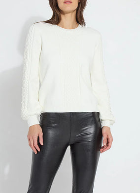 Crafted from cozy jacquard, the Leanna Cozy Pearl Sweater features strategically placed cables on the front and sleeves, a crew neck, and a square, cropped fit. White pearls are hand-stitched between the cables on the sleeves employing a gradient effect. You will feel and look fabulous when styling this top with any of your favorite bottoms.