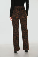 Load image into Gallery viewer, Leopard print pants worn by a person on a white background

