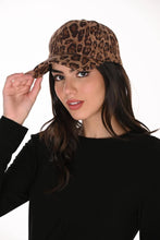 Load image into Gallery viewer, A woman wearing a leopard print baseball cap and a black long-sleeve top, posing against a solid white background.
