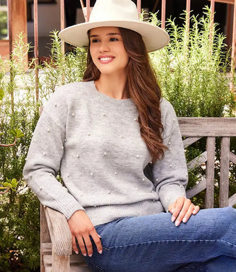 Experience warmth and elegance this winter with our light heather gray pearl crewneck sweater. Adorned with pearl details on the front and arms, this cozy and chic garment is suitable for any event. From formal occasions to casual outings, this sweater is sure to receive admiration.