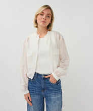 Load image into Gallery viewer, Woman wearing an off-white sheer jacket over a white shirt and blue jeans on a plain background.
