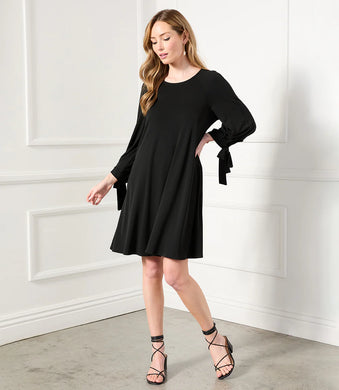 Karen Kane's Lily Swing Dress is a soft jersey-knit fabric and loose-fitting swing silhouette make it versatile enough for work hours and evening dinner. The bows placed on the sleeves adds extra interest while the side pockets offer functionality. Color- Black. 3/4 Sleeve with ties Center back invisible zipper. Side pockets. Swing dress design. Fabric -68% Acetate. 27% Polyester. 5% Spandex. Care- Dry clean.