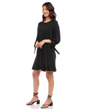 Load image into Gallery viewer, Karen Kane&#39;s Lily Swing Dress is a soft jersey-knit fabric and loose-fitting swing silhouette make it versatile enough for work hours and evening dinner. The bows placed on the sleeves adds extra interest while the side pockets offer functionality. Color- Black. 3/4 Sleeve with ties Center back invisible zipper. Side pockets. Swing dress design. Fabric -68% Acetate. 27% Polyester. 5% Spandex. Care- Dry clean.
