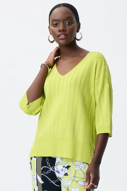 All eyes are on this striking lime green top designed by Joseph Ribkoff. Made from a lightweight summer sweater knit, our Lydia top offers a touchable texture that is super soft against the skin. A v split on each side is enhanced with silver rivet accents, while the V-neck design allows you to show off your favorite jewelry pieces.  Color - Lime 3/4 Sleeve. Lightweight sweater knit.