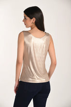 Load image into Gallery viewer, Woman wearing a gold sleeveless top and dark pants on a white background.
