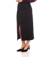 Load image into Gallery viewer, Model wearing a long black skirt with a front slit, purple blouse and black heels against a white background.
