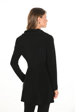 Load image into Gallery viewer, Woman wearing a long black jacket against a white background.
