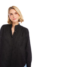 Load image into Gallery viewer, Woman wearing a black blouse with embellishments against a white background.
