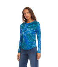Load image into Gallery viewer, Woman wearing a bright blue tie dye patterned long-sleeve top and jeans against a white background.
