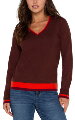 This long-sleeve sweater is the epitome of style, merging modern design with classic comfort seamlessly. It showcases striking color-block accents on the sleeves, neckline, back, and lower hem, lending a modern edge to the traditional shape. Made from a soft, cozy knit material, it's fashioned to provide warmth and fashion-forward appeal throughout the season.