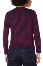 Load image into Gallery viewer, Model wearing a burgundy and navy striped sweater with dark jeans against a white background.

