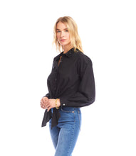 Load image into Gallery viewer, Woman wearing a long sleeve black shirt with a tie waist and blue jeans against a white background.
