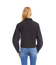 Load image into Gallery viewer, Woman wearing a long sleeve black shirt with a tie waist and blue jeans against a white background.
