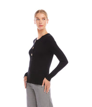 Load image into Gallery viewer, Woman wearing a black long sleeve top with decorative buttons and plaid black and white pants on a white background.
