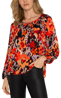 Experience the allure of nature with our elegant long-sleeve shirred woven blouse, featuring a lively burnt orange floral print. Made from a delicate woven fabric, this blouse flows beautifully, providing comfort and allowing breathability. This vibrant color top features long sleeves, ideal for day-to-evening wear, and its loose fit guarantees freedom of movement for lasting comfort.