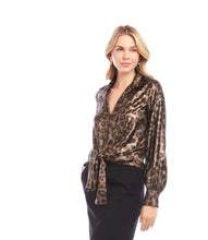Load image into Gallery viewer, Woman wearing a leopard print blouse and black skirt against a white background.

