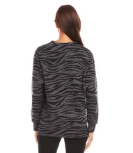 Load image into Gallery viewer, Experience ultimate comfort and warmth in our cozy zebra print long sleeve v-neck sweatshirt. Perfect for both leisurely days and cooler weather, this top pairs effortlessly with leggings or denim for a casual yet stylish look.
