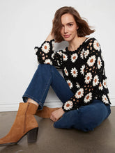 Load image into Gallery viewer, Woman wearing a black floral crochet sweater , blue jeans and brown boots sitting on the floor.

