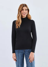 Load image into Gallery viewer, Woman wearing a black mock neck top and blue jeans against a light gray background.
