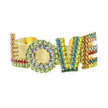 Load image into Gallery viewer, Sparkle and shine your way out of the mundane with the LA LA LOVE Cuff in Antique Gold! Crafted with antique gold-plated brass and high-quality crystals in a variety of rainbow colors, this cuff is adjustable for any wrist size and sparkles on the daily with its luxurious shine.   Color- Gold, blue, green, pink, red, yellow, orange. Antique gold plating over brass. Premium crystals. One size, adjustable.
