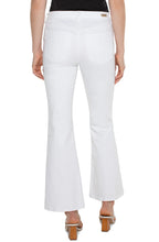 Load image into Gallery viewer, Model wearing white denim bootcut jeans with welt pockets, white sandals and black top against a white background.
