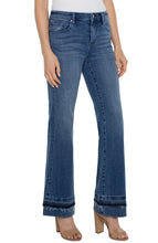 Load image into Gallery viewer, The Lucy Bootcut in Vandever features a let-down hem to give you vintage qualities while still keeping comfort in mind. Slim through the hips and thighs, this slimming denim releases at the knee and leg opening to create the beautiful bootcut shape. Everyone loves Lucy...   Color- Vandever. 32&quot; Inseam. Mid-rise. Let down hem. 5-pocket styling details. Set-in waistband with belt loops. Zip-fly with single logo button closure. Fabric -63% Cotton. 21% Lyocell. 14% Polyester. 2% Elastane.
