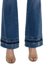 Load image into Gallery viewer, The Lucy Bootcut in Vandever features a let-down hem to give you vintage qualities while still keeping comfort in mind. Slim through the hips and thighs, this slimming denim releases at the knee and leg opening to create the beautiful bootcut shape. Everyone loves Lucy...   Color- Vandever. 32&quot; Inseam. Mid-rise. Let down hem. 5-pocket styling details. Set-in waistband with belt loops. Zip-fly with single logo button closure. Fabric -63% Cotton. 21% Lyocell. 14% Polyester. 2% Elastane.
