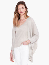 Load image into Gallery viewer, Worn open or tied at the front, this lightweight relaxed-fit cardigan brings draped comfort and style to any outfit. Designed to sit slightly below the hip with an 3/4 length sleeves. Made with a soft, breathable T-shirt yarn with metallic lurex added in to give it just the right amount of shine.  Color- Light sand. Subtle sparkle throughout. Cape design. Lurex yarn, wear open or tied. Lightweight.
