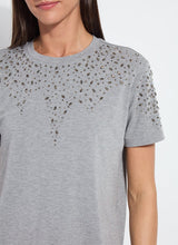 Load image into Gallery viewer, Close-up of dark grey short sleeve top with rhinestone embellishments worn by a model against a white background.
