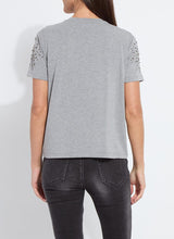 Load image into Gallery viewer, Model wearing a rhinestone embellished dark grey, short sleeve top and grey jeans against a white background.
