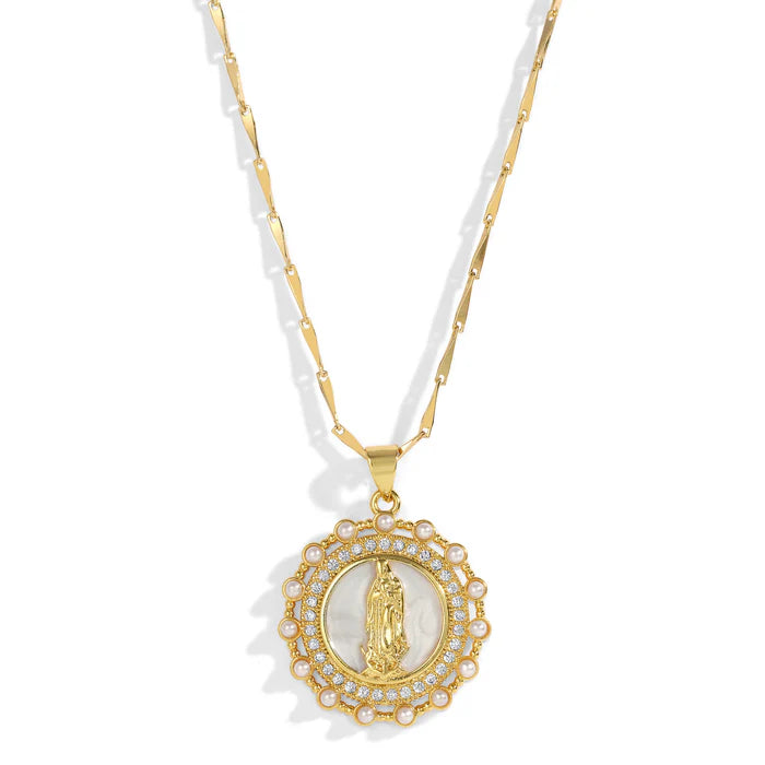 Gold necklace with a round pendant with pearls and crystals surrounding a white pearl shell with a gold Virgin Mary icon against a white background.