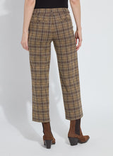 Load image into Gallery viewer, Model wearing brown plaid sparkle pants and brown suede boots against a white background.
