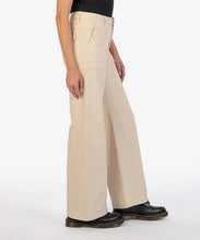 Load image into Gallery viewer, Elevate your style with these Meg Utility Pocket High Waist Wide Leg Pants from Kut from the Kloth (KB50101-BEIGE). Featuring a neutral beige color, flap pockets, and full-length wide legs, these pants add a professional touch to any outfit. With a high rise and 31-inch inseam, these pants provide a true to size fit and are both stylish and practical.  Color- Beige. Front deep functional pockets. Back functional flap pockets. Wide leg. High rise. 31-inch inseam. Gold button closure. Belt loops.
