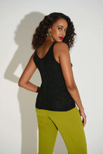 Load image into Gallery viewer, Woman wearing a sparkling black top and green pants against a white background.
